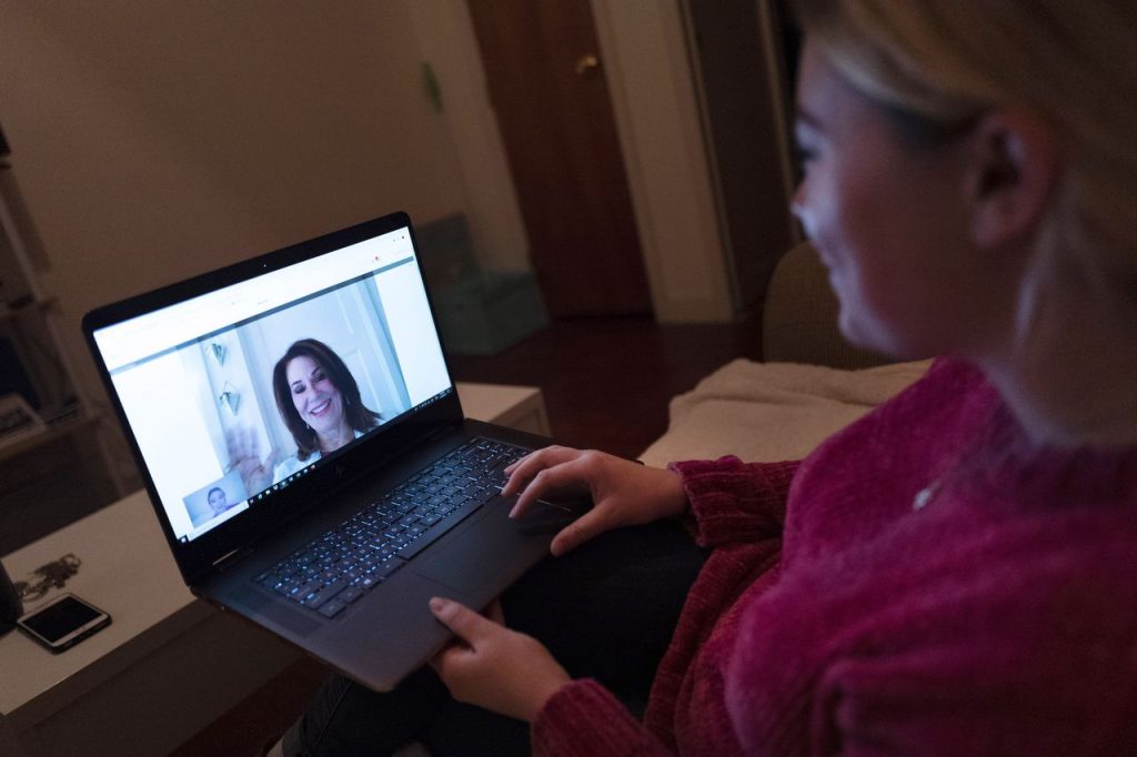 A patient sits in the living room of her apartment in New York City during a telemedicine video conference with a doctor. (Mark Lennihan/AP)AP