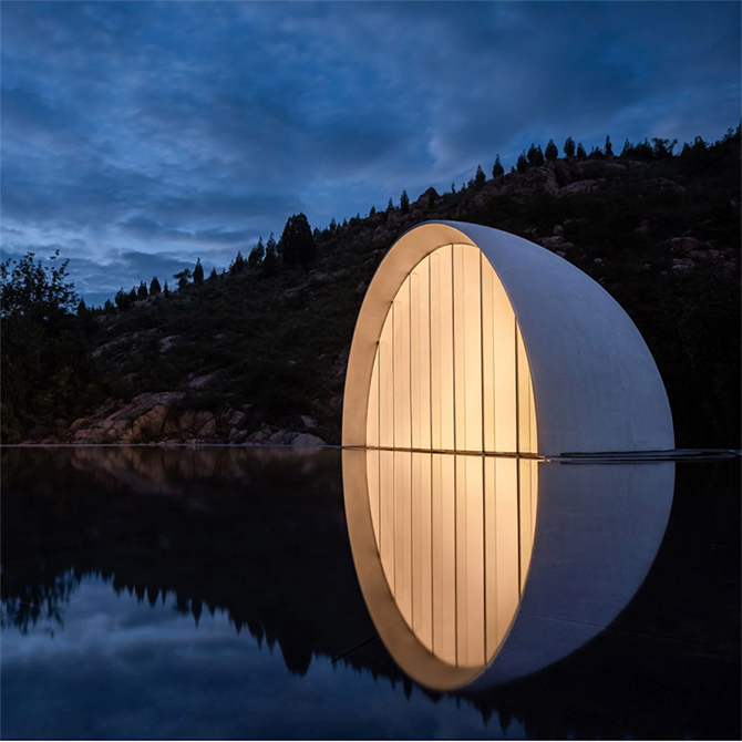 Set in the dramatic landscape surrounding Mount Tai, this ceremonial hall is topped with a semicircular window that reflects on a pool of water to create a moon-like effect when illuminated.