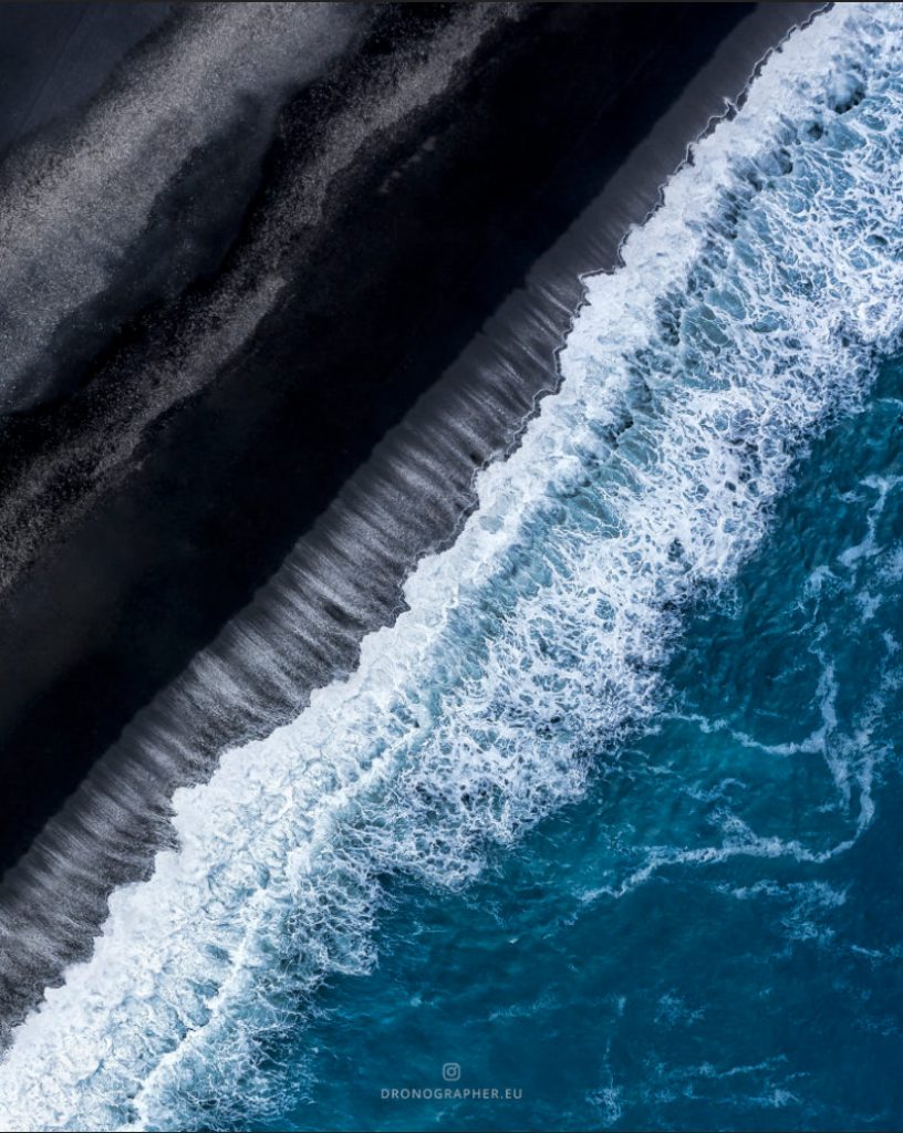 overhead view of a black sand beach